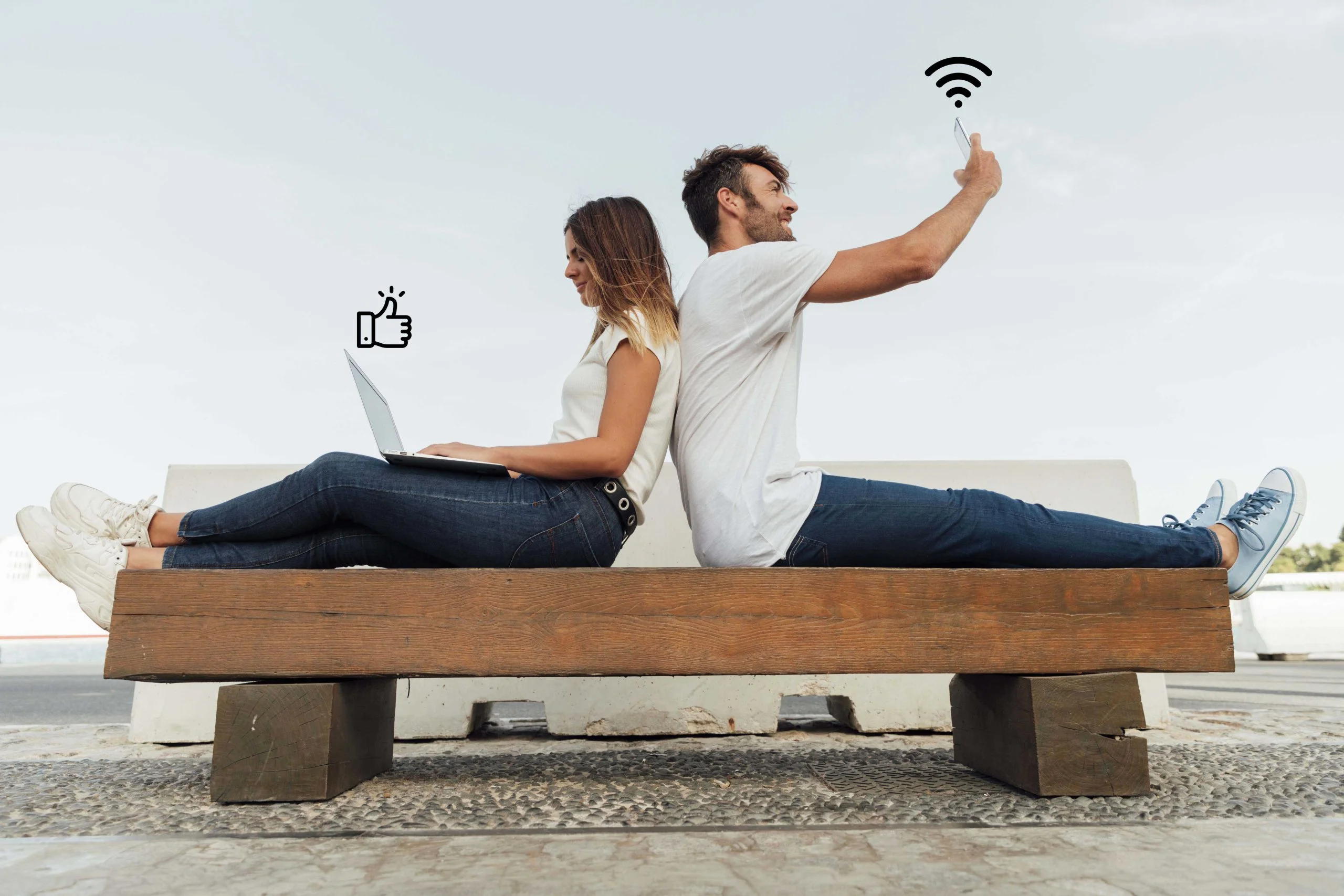 "A boy and girl sitting together, using mobile & laptop connected with Telsim nbn home internet wifi